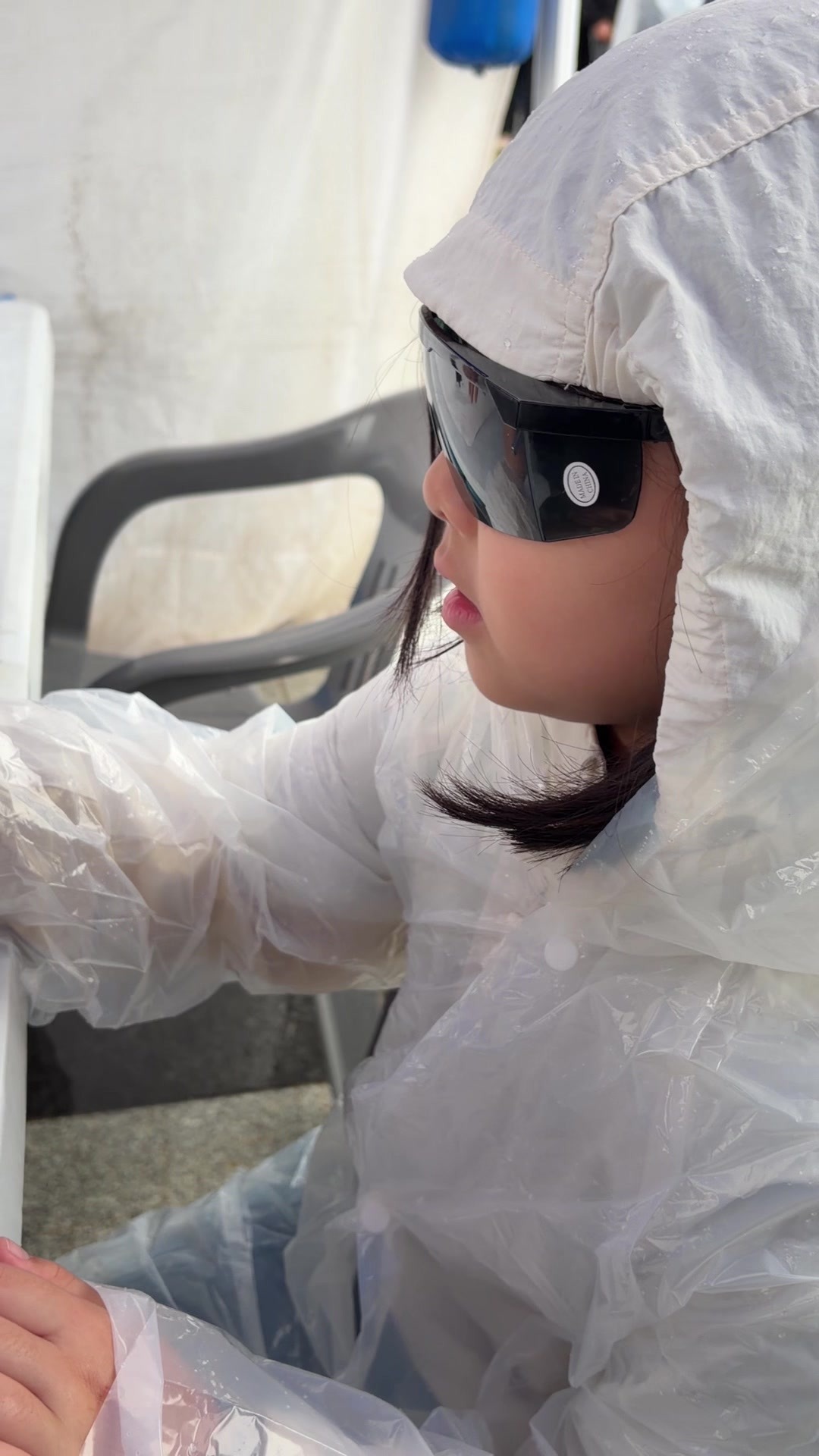 A child wearing safety goggles for laser target shooting