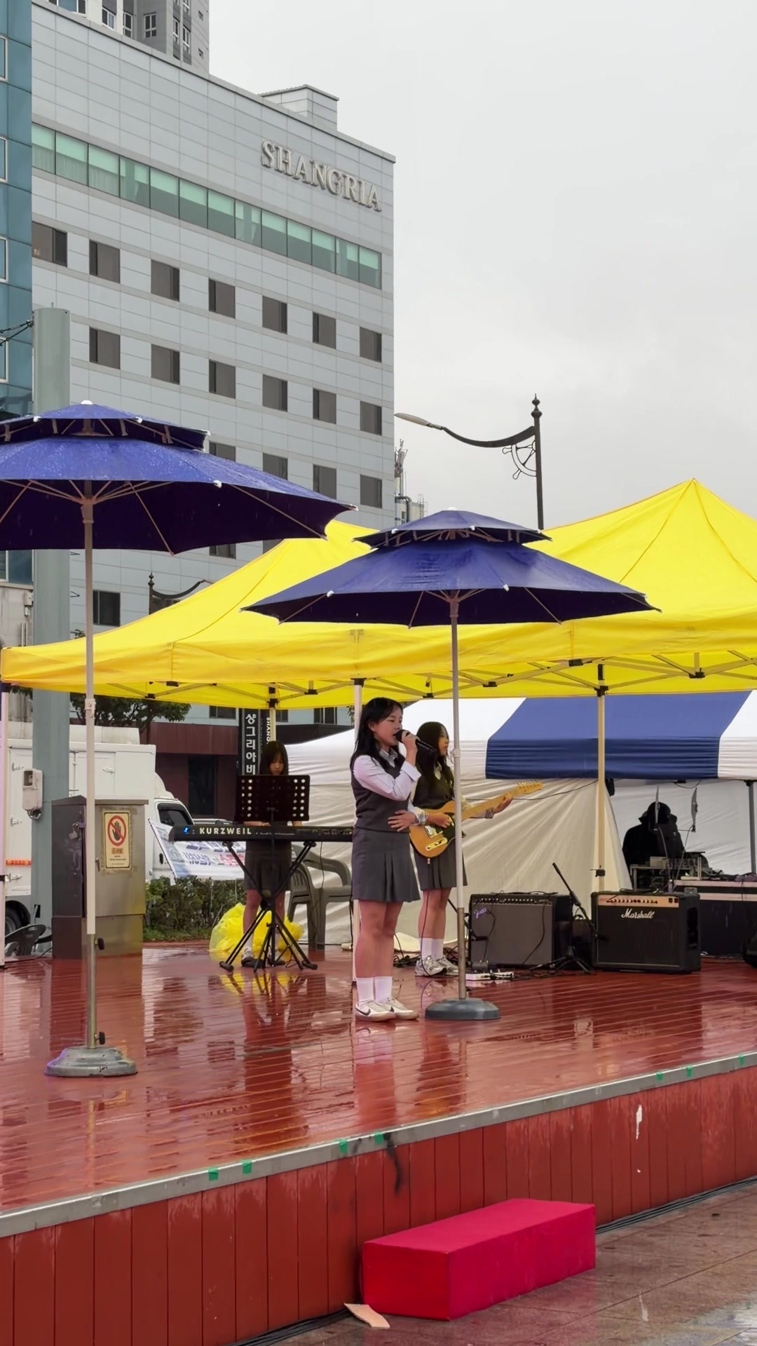 Student band on the wet outdoor stage